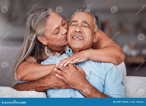 Happy Senior Couple Hug In Home Retirement Lifestyle Together In