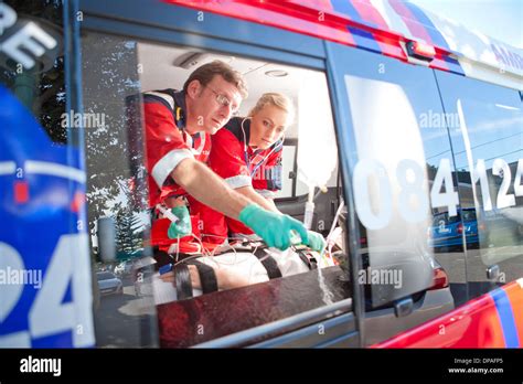 Paramedics Monitoring Patient In Ambulance Stock Photo Alamy