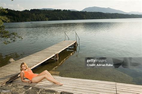 Woman Relaxing On Jetty High-Res Stock Photo - Getty Images