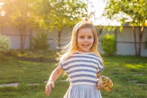 Premium Photo Portrait Of Smiling Girl Standing Outdoors