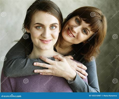 Happy Senior Mother Embracing Adult Daughter Laughing Together Older