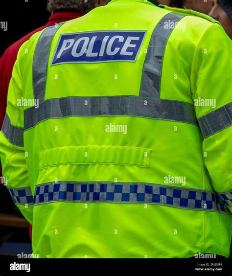 Bright Yellow High Visibility Jacket Police Uniform Worn By An On Duty