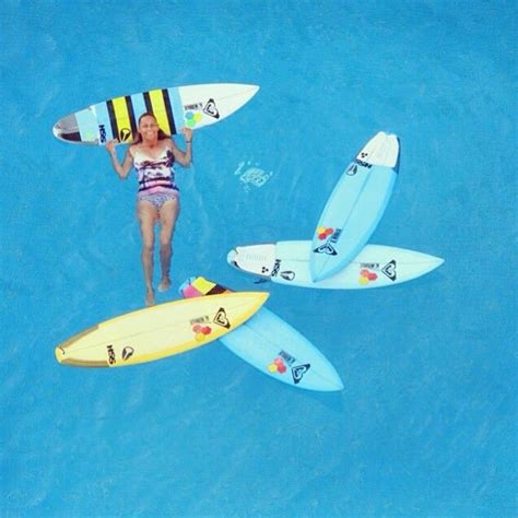 Two Women Holding Surfboards In The Water