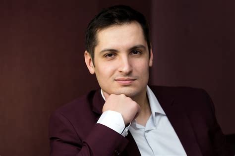 Premium Photo Handsome Brunette Man Sitting On The Sofa
