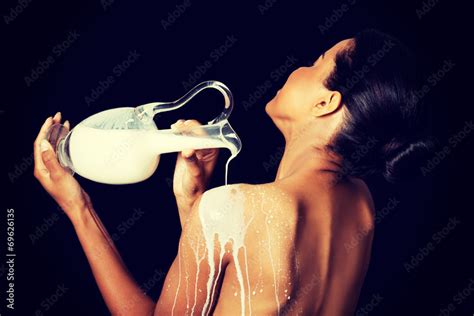 Beautiful Naked Woman Is Pouring Milk On Her Back Stock Photo Adobe Stock