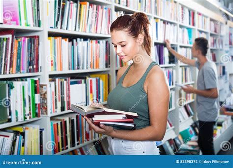 Interested Teenager Girl Reading New Book In Shop Stock Photo Image