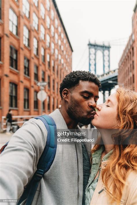 A Multiethnic Couple Is Taking A Selfie In The Brooklyn With Manhattan