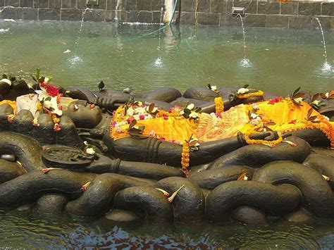 giant statue  sleeping hindu god vishnu  coils   snake