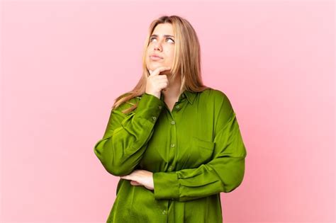 Premium Photo Curvy Pretty Blonde Woman Thinking Feeling Doubtful And Confused
