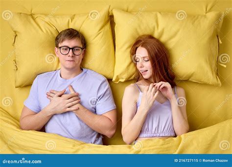 Happy Couple Lying In Bed Under Duvet After First Sex Experience Man Is Surprised By Skills Of