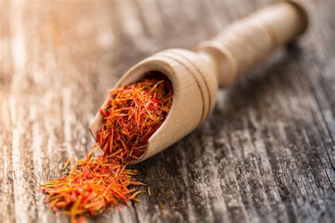 Premium Photo | Saffron seasoning in a wooden spoon close up