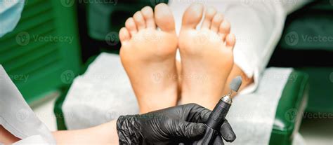 Chiropodist prepares foot file machine 21906159 Stock Photo at Vecteezy