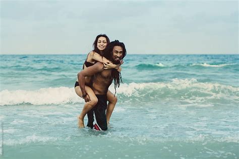 Playful Couple At The Beach By Stocksy Contributor Stephen Morris