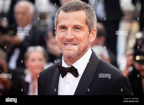 Guillaume Canet poses for photographers upon arrival at the awards ...