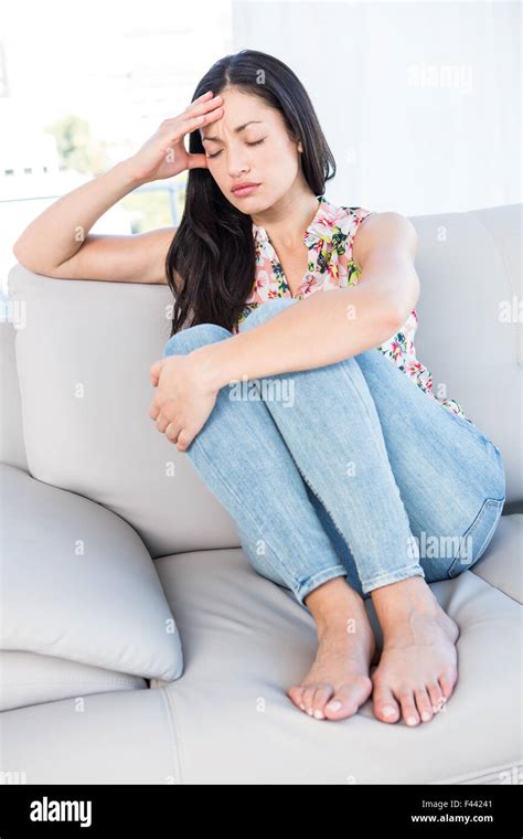 Pretty Brunette With Headache On Couch Stock Photo Alamy