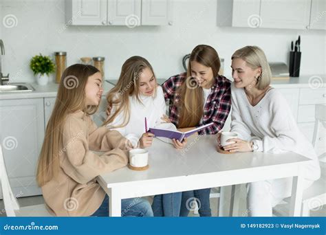 Two Lesbian Female In Casual Clothes Checking Homework Their Daughters Stock Image Image Of