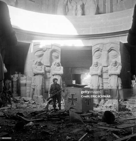 US soldier stands in front of the sculptures by Franz Metzner in the