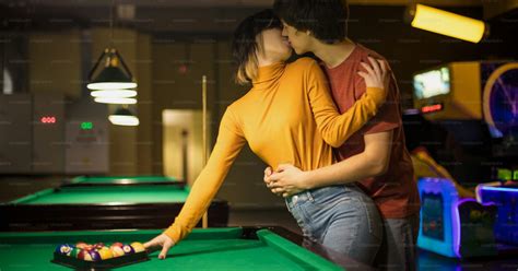 The Couple Is Kissing In The Billiard Room Couple In Playroom Photo