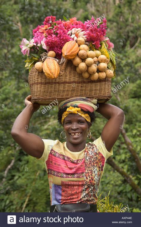 Woman Carrying Baskets Of Fruit On Her Head Grenada Caribbean Stock