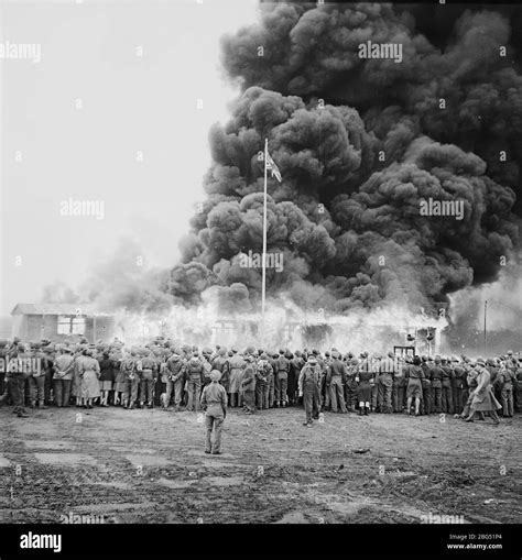 Second World War documentary. Crowds watch as British soldiers set fire to the last remaining ...