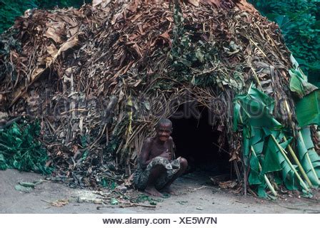 Africa Zaire People Pygmy person sitting outside hut Wambuti Pygmies ...