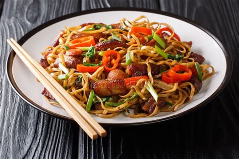 Stir Fry From Chow Mein Noodles With Pork And Vegetables Close Up On A