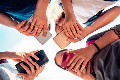 Premium Photo | Kids playing video games on smart phone after school