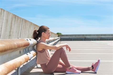 Premium Photo Fit Sporty Woman Sitting Resting After Working Out Outside