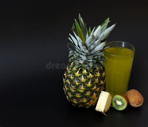 A Tall Faceted Glass Of A Mixture Of Fruit Juices On A Black Background