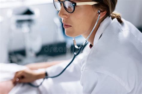 Doctor Listening Heartbeat Of Patient With Stethoscope Stock Image