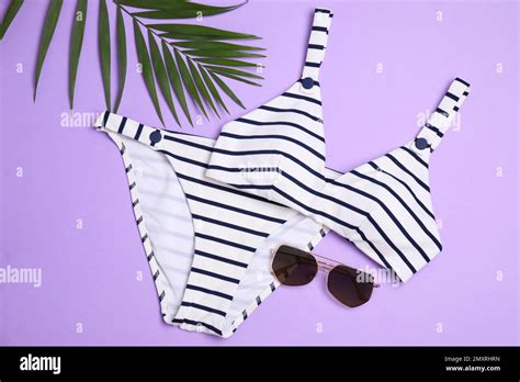 Striped Bikini Sunglasses And Green Leaf On Violet Background Flat Lay Beach Objects Stock