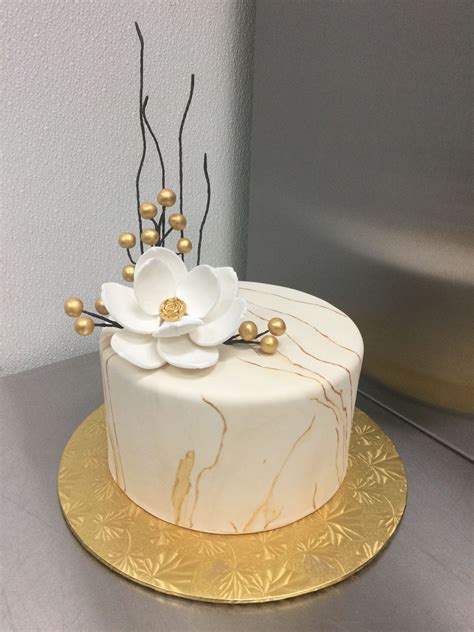 Elegant Birthday Cake With Gold Decoration And Flowers