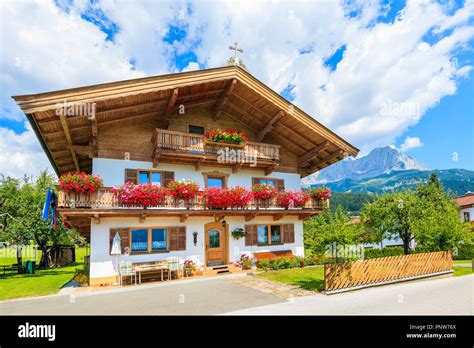 Traditional alpine house with balconies decorated with flowers in Going ...