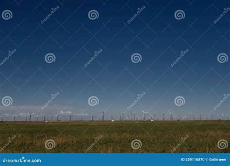 Aerial View Over The Farm Landscape And Wind Turbines Generating Clean