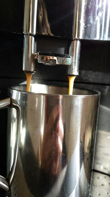 Premium Photo Coffee Pouring Out From Coffee Maker In Cafe