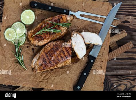 Grilled Chicken Filet With Herbs On A Paper Stock Photo Alamy