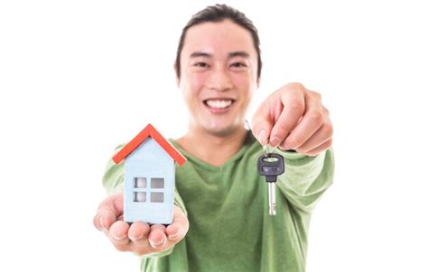 Premium Photo Man Holding Piggy Bank And Model Of House In Hands