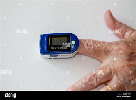 Pulse Oximeter On Person S Finger Measuring Their Oxygen Saturation