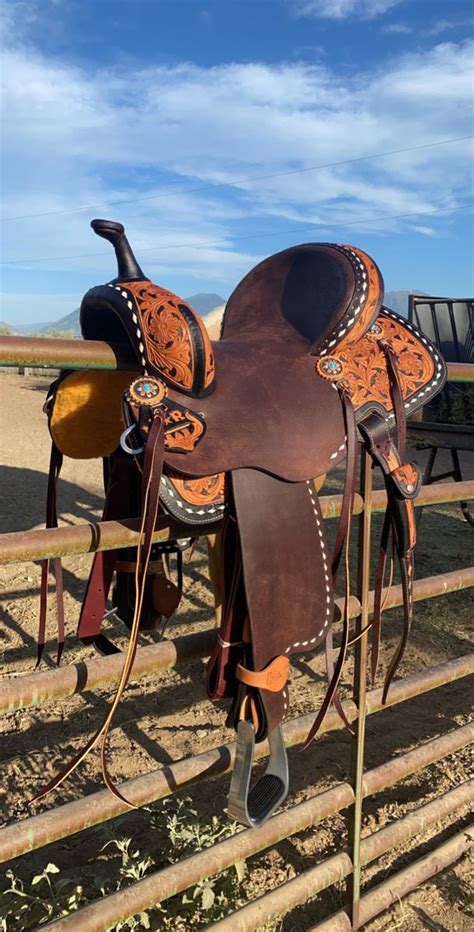 Western Barrel Racing Saddles on Wooden Fence