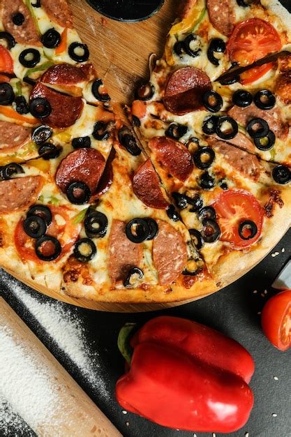 Free Photo Top View Salami Pizza On Stand With Tomatoes Olives And