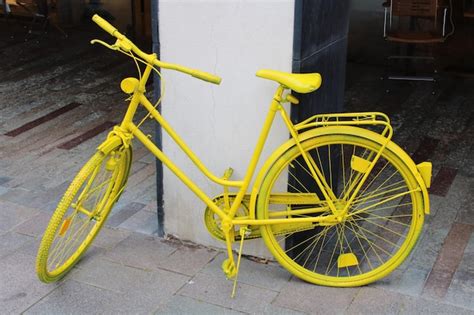 Premium Photo Yellow Bicycle Parked On Street