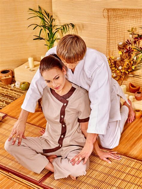 Male Masseur Doing Japanese Massage With Bamboo Sticks On Beautiful