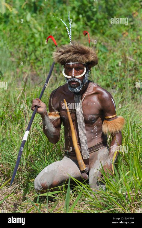 Dani man wearing kotekas (penis gourd) with arrow and bow at Baliem