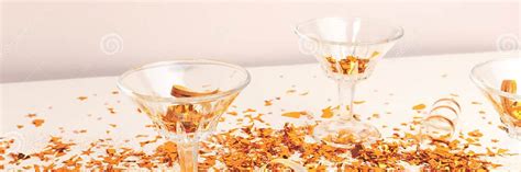 Banner With Crystal Glasses And Golden Confetti In Front Of Beige Background Stock Image