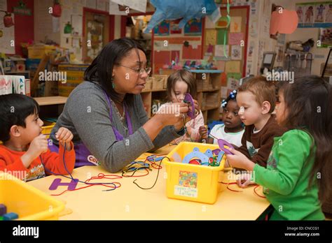 Preschool classroom teacher and students Stock Photo - Alamy