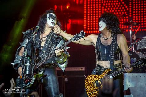 Two Men Dressed As Kiss Band Members Performing On Stage