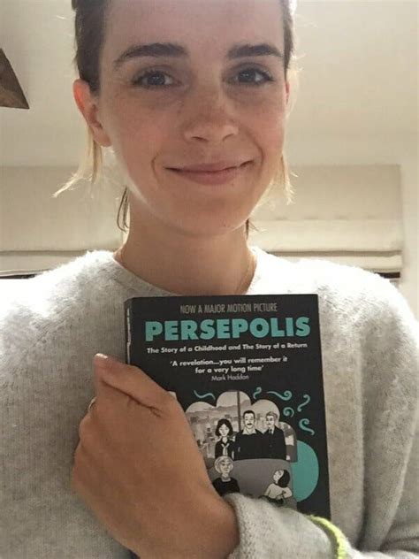 A Woman Holding Up A Book In Front Of Her Face With The Title