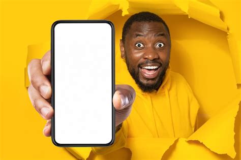 Premium Photo Unbelievable Offer Shocked Black Man Holding Smartphone