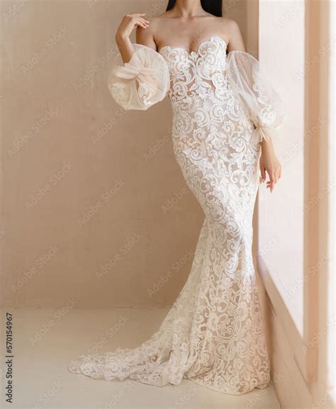 Beautiful Bride With The Naked Shoulders Dressed In The White Long