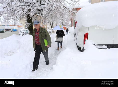 Gospic, Croatia, on February 27, 2023. People walk through snow ...